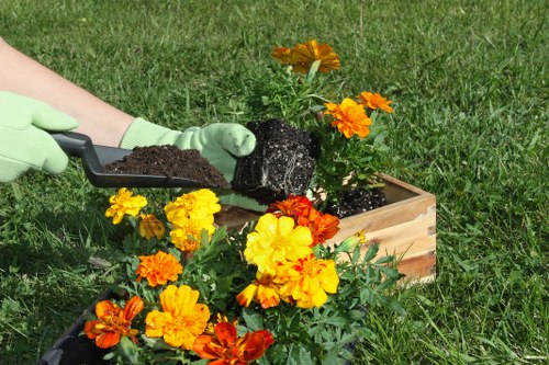 Gardener using protective gear while operating machinery in a garden